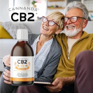 Older happy couple with a bottle of Cannanda CB2 Hemp Seed Oil (Orange Creamsicle flavor)