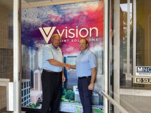Steve Baylerlein, CEO and Mark Zerona shake hands.