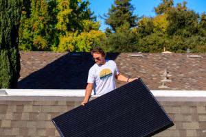 Arvo Solar team member installs solar panel.