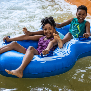 boy and girl in dual inner tube at Big Kahunas