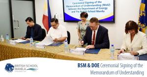 Representatives from BSM and DOE sign an agreement