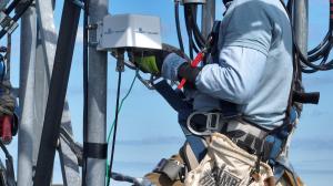 Man installing Smart Tower on cell tower