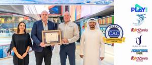 Group photo of Emaar Entertainment receiving the Certified Autism Center™ framed certificate from Myron Pincomb, IBCCES Board Chairman