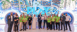 Emaar Entertainment - Play DXB  team receiving the CAC framed certificate with staff group photo and IBCCES Team