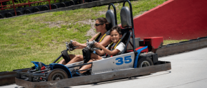 boy and other rider on go-carts driving track at Boomers Park
