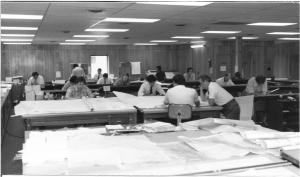 Black and white photo, early partnership pre digital era, engineers drafting paper documents.