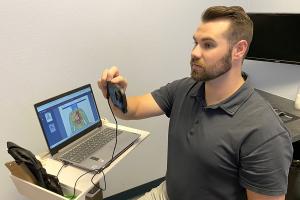 Dr. Chris Robey demonstrates non-invasive imaging procedure for patients.