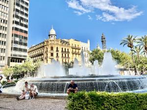 Photo of people in front of a fountain in Spain