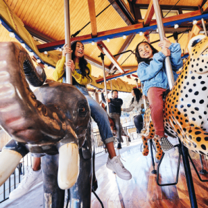 two girls riding carousel in Salt Lake