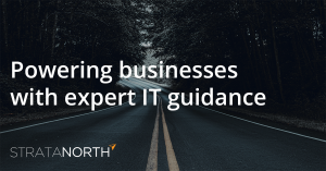 Background image: A curving road through a forest. Overlay text: "Powering businesses with expert IT guidance - StrataNorth"