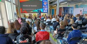 Students watch a presentation about the future of finance.