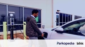 Man charging his electric vehicle.