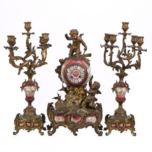 Three-piece French clock set (clock and two matching five-arm candelabras), French porcelain with elaborate gilt metal fittings, maroon ground with a cherub scenic décor (est. $1,500-$3,000).