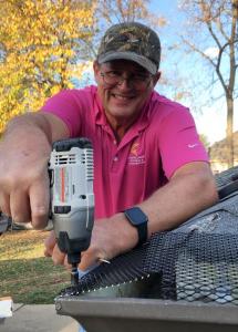 Roofing professional installing gutter screens on a roof