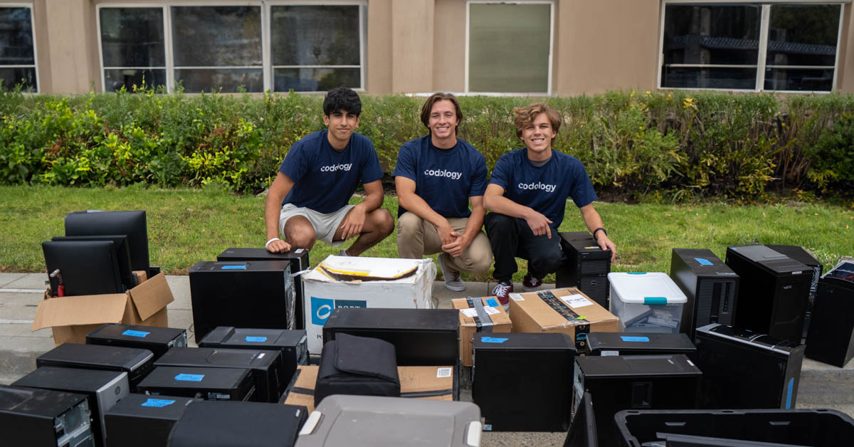 Neal Chopra (left), Ethan Thornberg (middle), and Dylan Witter (right) with the donated devices.