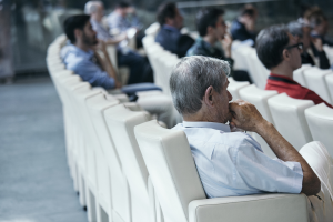 Audience in a Conference showing a couple of listeners.