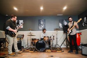 Men recovering from addiction find a healing outlet through music at Serenity Lodge's recording studio.