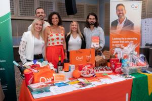 Cinco pessoas na foto representando a equipe da empresa Owl Financial, todos sorrindo para a foto.
