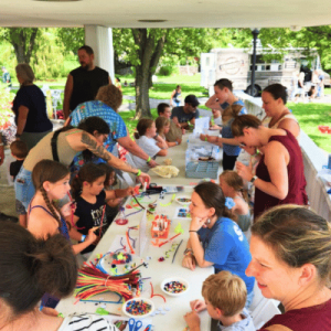 group activity outdoors craft pavilion with kids and adults