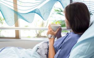 A woman in a hospital recovery room gazes out of the window. A natural view and some sound waves signifying a natural soundscape are visible in the background.