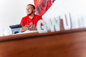 Male student inside residence hall laughing