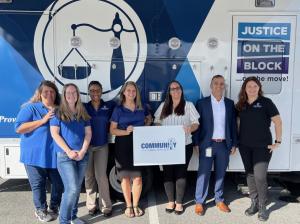 CLS team members pose in front of the Justice Bus