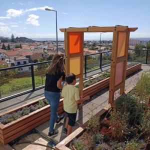 A NIITE employee and a young child walk together through the outdoor gardens