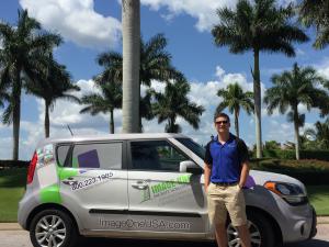 Nikko Conn, owner of Ft. Myers-based Image One franchise, stands in front of a work vehicle. 