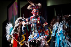 A native dancer wearing regalia participates in the SACNAS Pow Wow