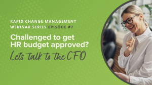 Picture of a smiling woman in an office, the title Challenged to Get HR Budget Approved? Let's talk to the CFO. Caption says: In this webinar ex-CFO, business advisor and Baylor University professor Michael Rodriguez discusses strategic approaches to h