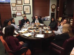 Visitors gather around for discussion at Shema Kolainu, School for children with Autism 