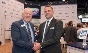 IADA Executive Director Wayne Starling (L) and AIN Media  Group President Ruben Kempeneer commemorate partnership.