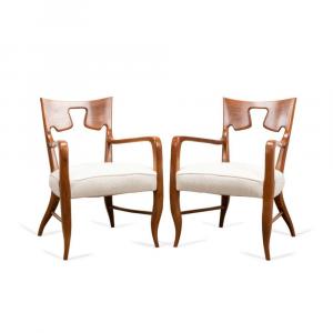 Pair of Gio Ponti (Italian, 1891-1979) walnut armchairs, circa 1946, having curved backs with keystone or puzzle piece voids and seats reupholstered in cream chenille fabric ($9,680).