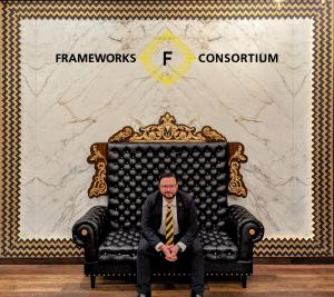 George Mayfield, CEO of Frameworks Consortium sitting on a couch
