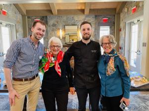 Standing, left to right: Devin Clemens, Jane Dean (wearing a scarf), Cameron Matthews, Susan Whitcomb (wearing a scarf).
