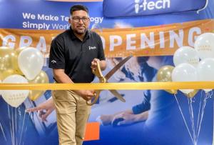 i-Tech Support's Zaheer Ali, Regional Manager of South Florida, cuts the ribbon on the new local branch