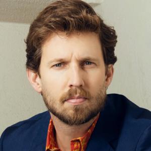 A shoulders-up photo of actor Jon Heder looking at the camera.