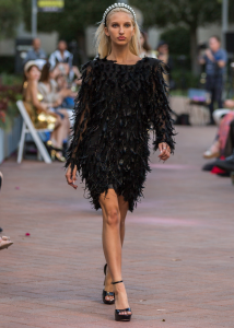 Woman in black dress on runway