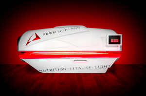 image of the fourth generation red light therapy bed with the lid closed and lights on.