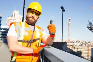 Tradesperson giving thumbs up to more AEDs and first aid training in Qld workplaces.