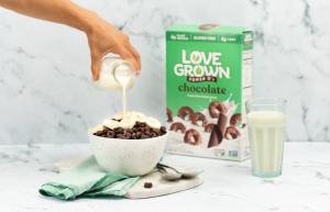 bowl-of-love-grown-chocolate-power-os-cereal-with-box-and-poured-milk