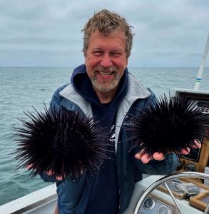 Catalina Offshore Products Inc. founder Dave Rudie holds a pair of sea urchins