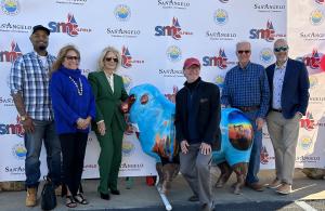 SMC Global owners Kevin Huber and Adam Feldman along with Mayor Brenda Gunter posing with SMC Oilfield's custom designed Sheep
