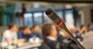 A microphone in the foreground with people in the background