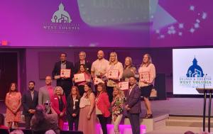 Recipients of the DeLand & Greater Volusia Chamber of Commerce Wellness Awards on stage, posing with their awards.
