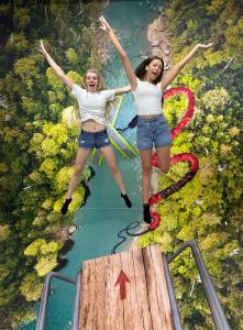 2 girls bungee jumping into nature