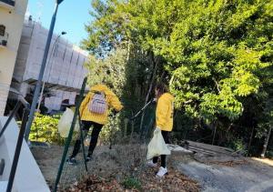 Scientology volunteers cleaning the gardens