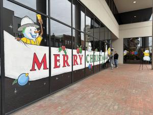 National welcomes parade-goers to use its lot on Saturday for public parking. The building features a newly painted window mural on its Main Street entrance, perfect for taking Christmas selfies after parking your car.