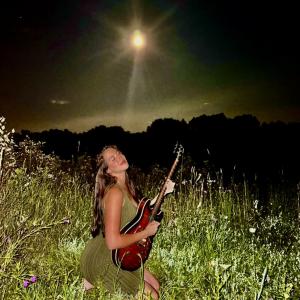 Musical artist Sage Bava poses with guitar on the cover of her 'Falling In' EP.
