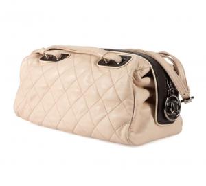 Circa 2006-2009 Chanel cream quilted lambskin Boston Duffel handbag with dark brown trim, gunmetal hardware, “CC” zipper charm and COA card (est. $1,000-$3,000).